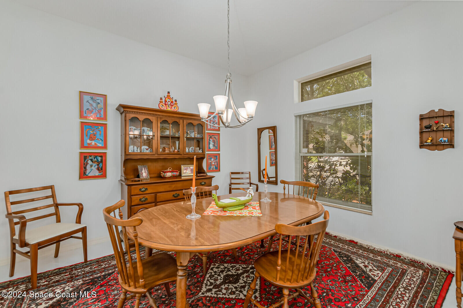 410 Oriole Lane Indialantic, FL 32903 - Photo 16 of 92 a view of a dining room with furniture a chandelier and wooden floor
