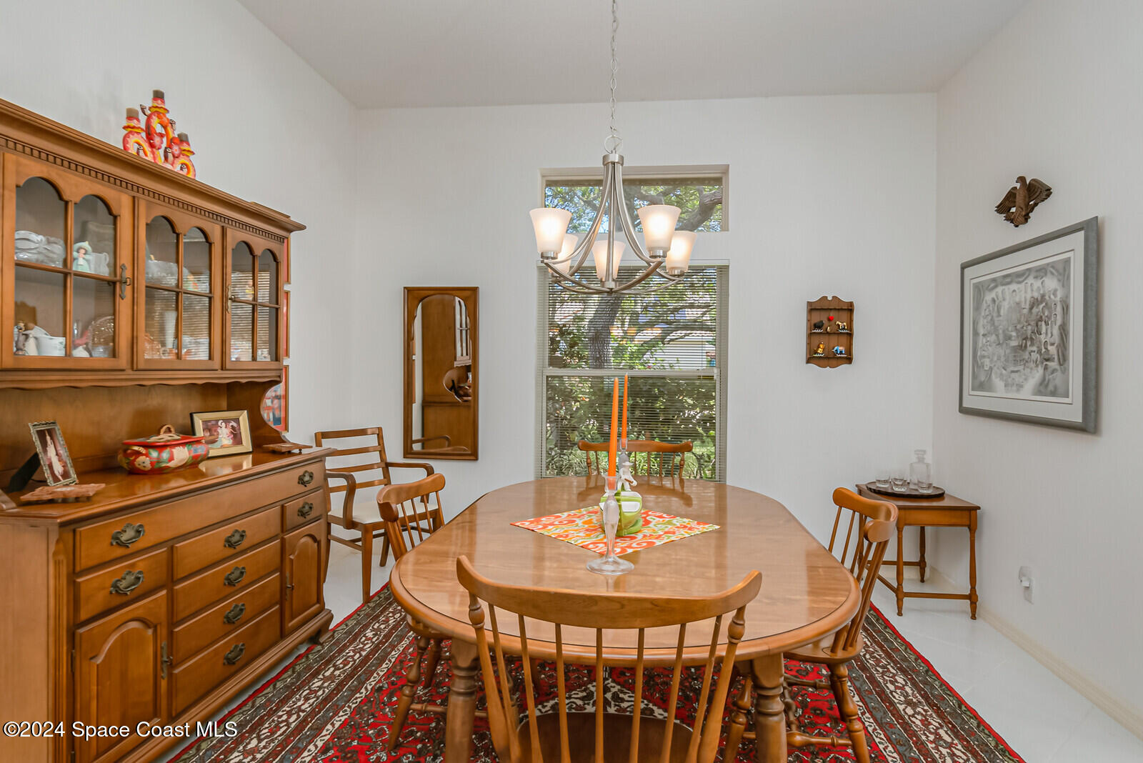 410 Oriole Lane Indialantic, FL 32903 - Photo 17 of 92 a view of a dining room with furniture a chandelier and wooden floor