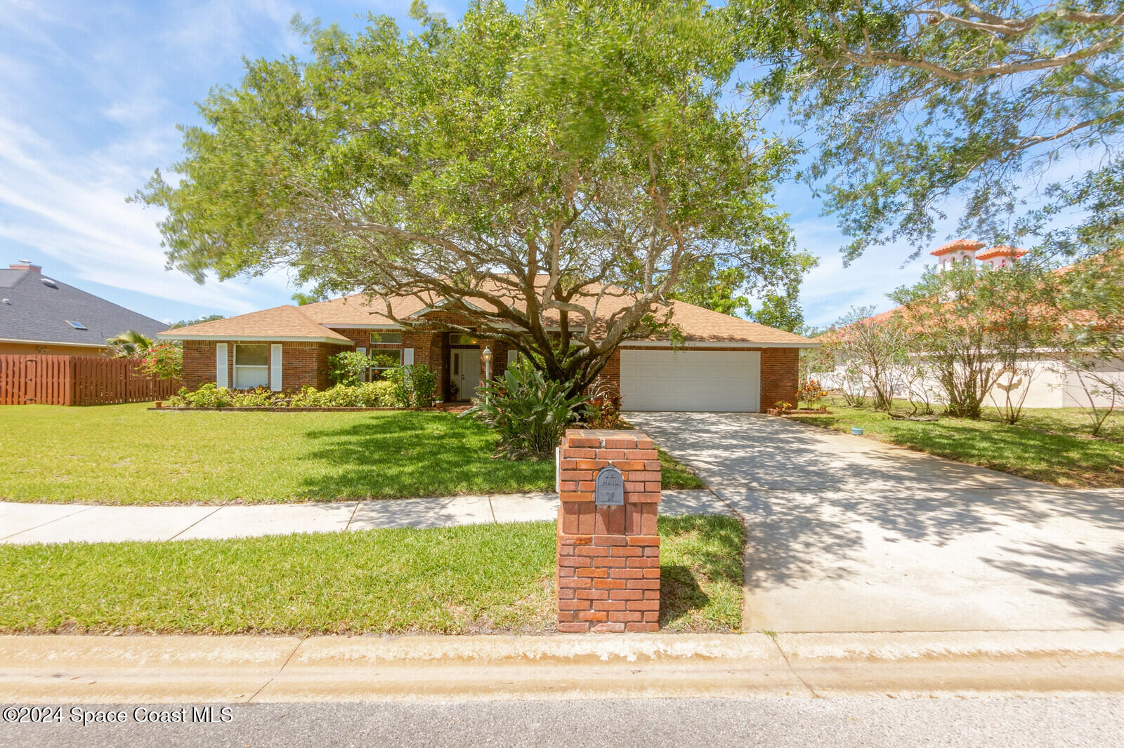 410 Oriole Lane Indialantic, FL 32903 - Photo 2 of 92 a front view of a house with a yard and garage