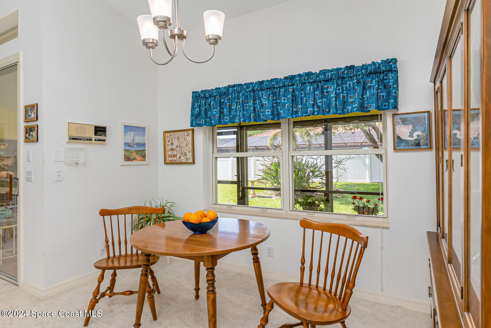 410 Oriole Lane Indialantic, FL 32903 - Photo 25 of 92 a view of a dining room with furniture wooden floor and a chandelier