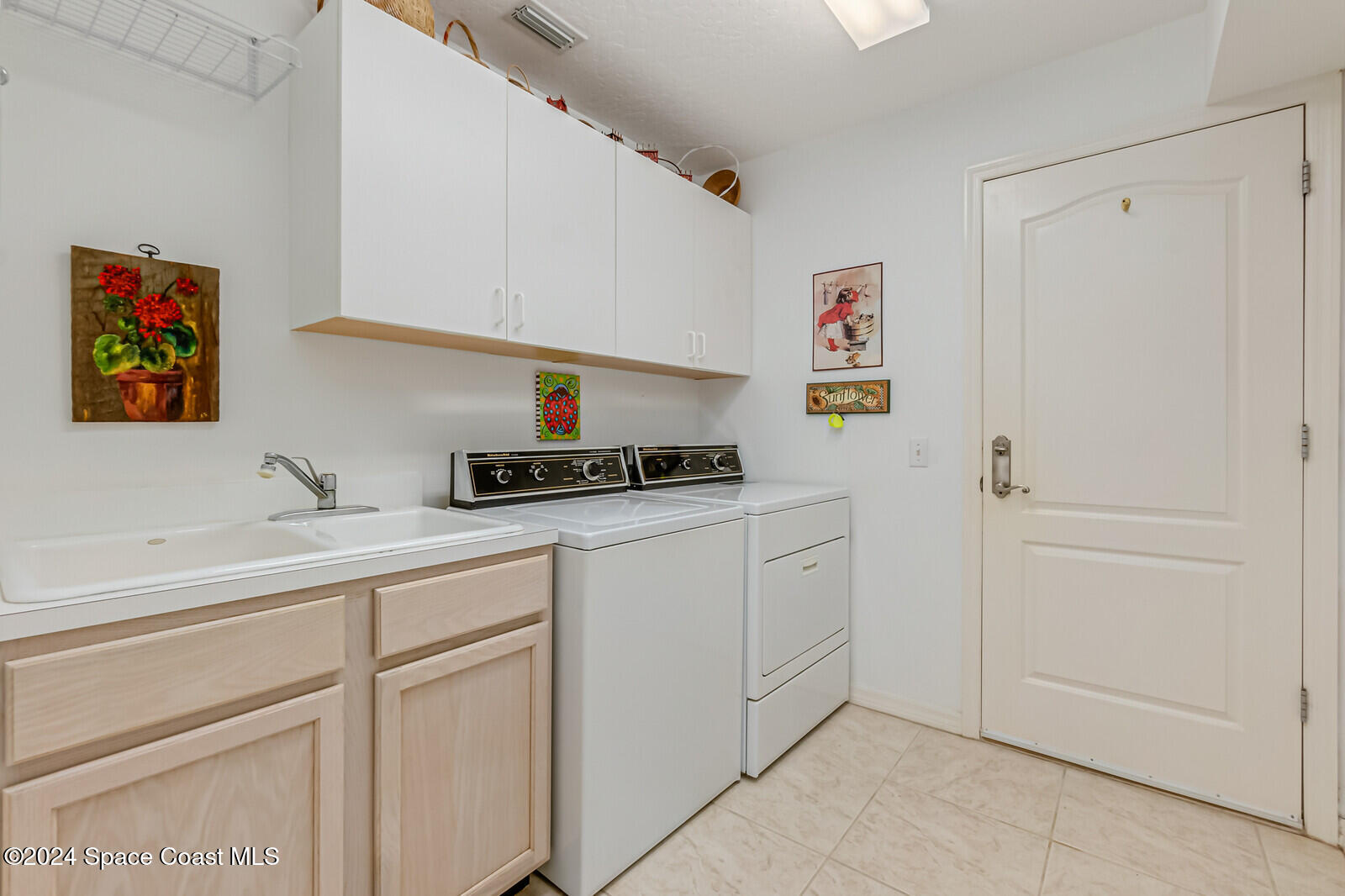 410 Oriole Lane Indialantic, FL 32903 - Photo 45 of 92 a kitchen with white cabinets and sink