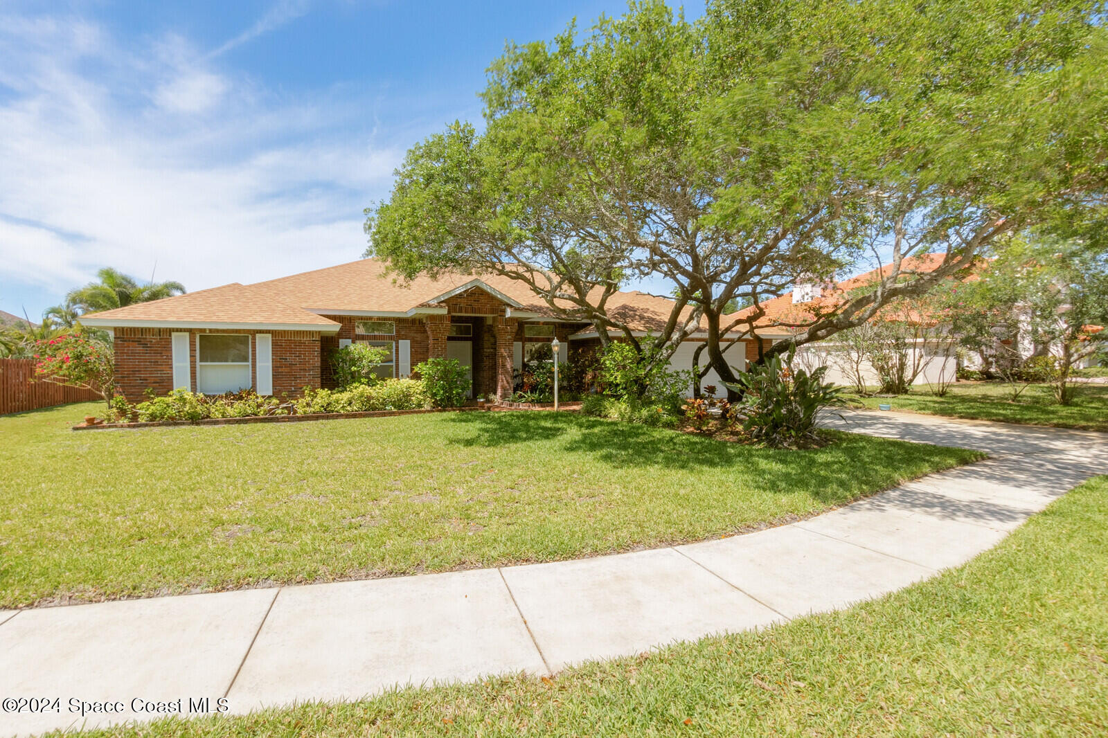 410 Oriole Lane Indialantic, FL 32903 - Photo 10 of 92 a front view of a house with a garden