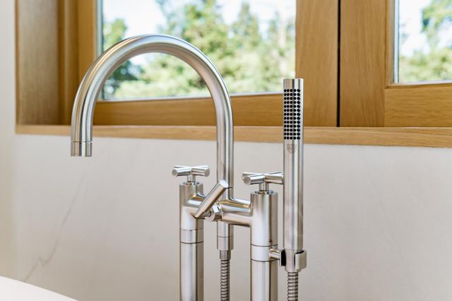 a bedroom with two beds and a large window