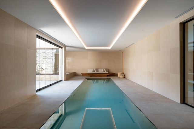 a living room with hard wood floor and a flat screen tv