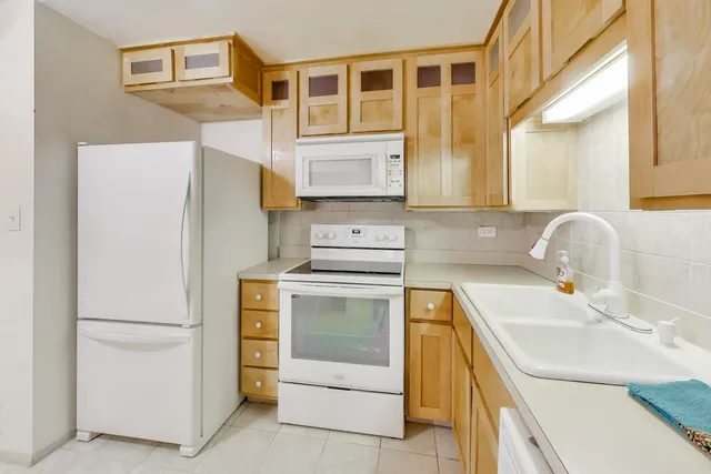 a kitchen with a sink and a refrigerator