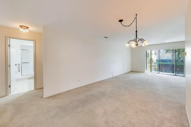 a view of a room with a windows and ceiling fan