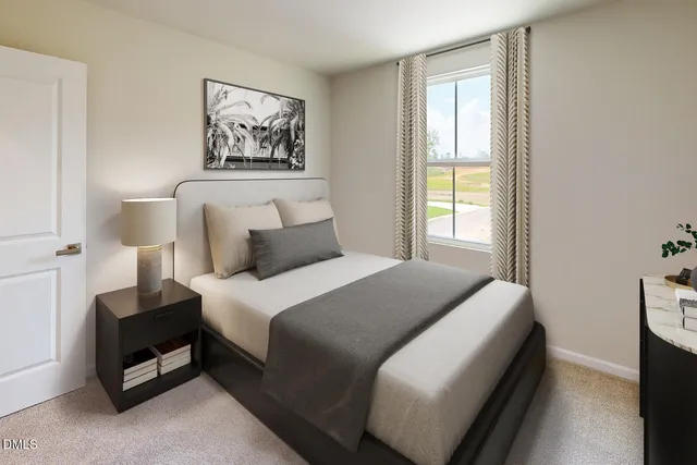 a bedroom with a white bed and a window