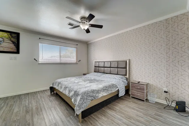 a bedroom with a bed and a chandelier