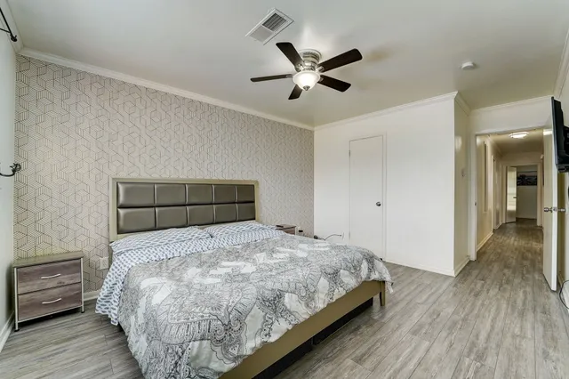 a bedroom with a bed and a chandelier