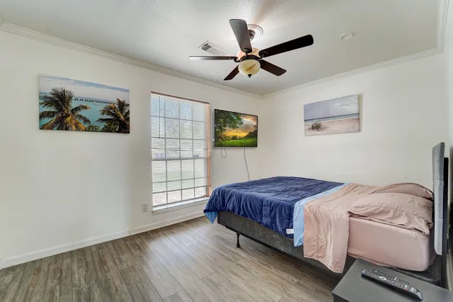 a bedroom with a bed and a painting on the wall