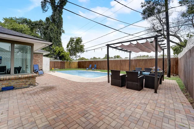 a view of a terrace with furniture and a backyard