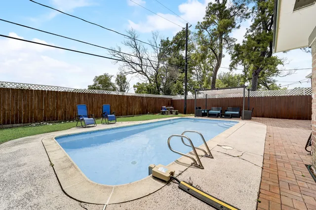 a view of a swimming pool with a yard