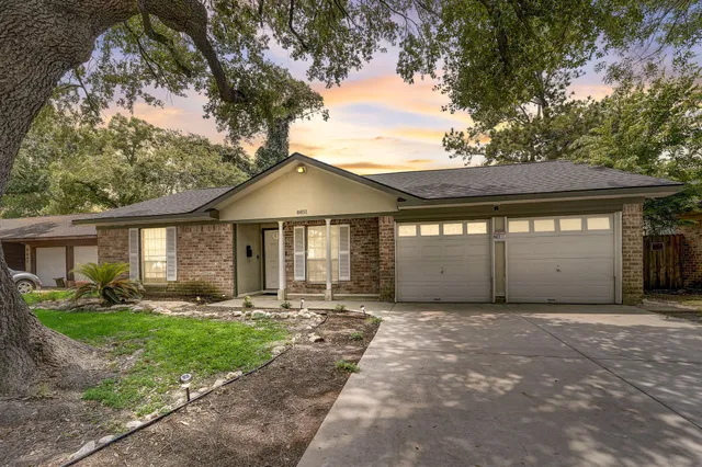 a front view of a house with a yard and table and chairs
