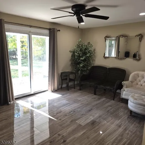 a view of a livingroom with furniture and a flat screen tv