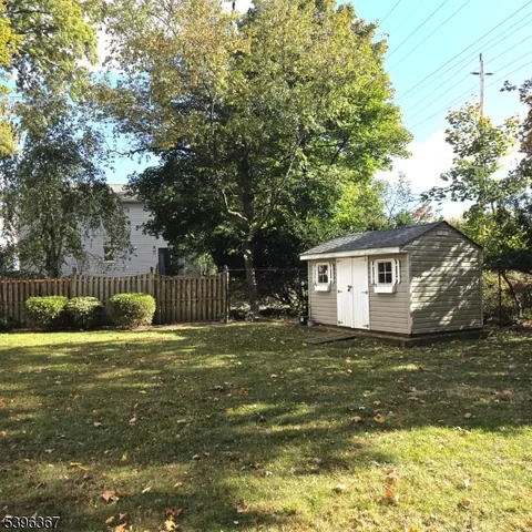 a backyard of a house with lots of green space and fountain