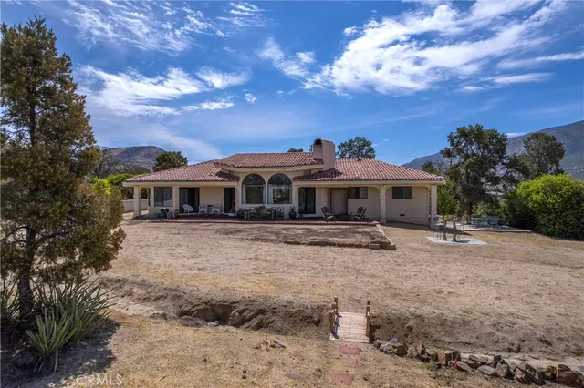 an aerial view of a house with mountain view