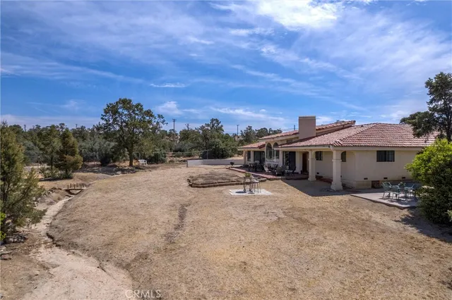 an aerial view of residential houses with outdoor space and mountain view