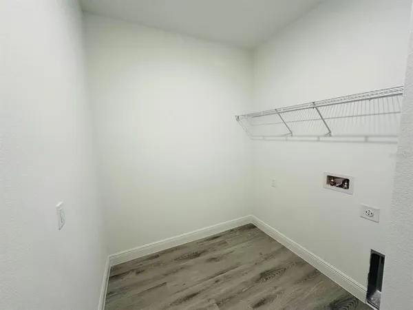 a view of a room with wooden floor