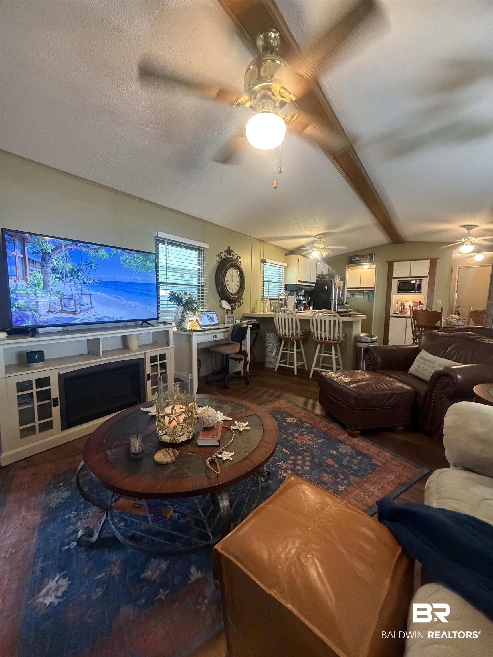 1620 Del Rey Drive Lillian, AL 36549 - Photo 9 of 45 Living area featuring wood-finish flooring, exposed ceiling beams, and multiple ceiling fans