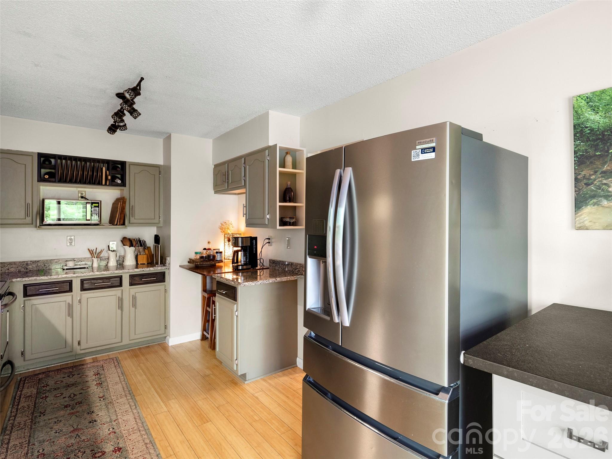 756 Pole Creasman Road Asheville, NC 28806 - Photo 14 of 29 a kitchen with stainless steel appliances granite countertop a refrigerator stove and sink