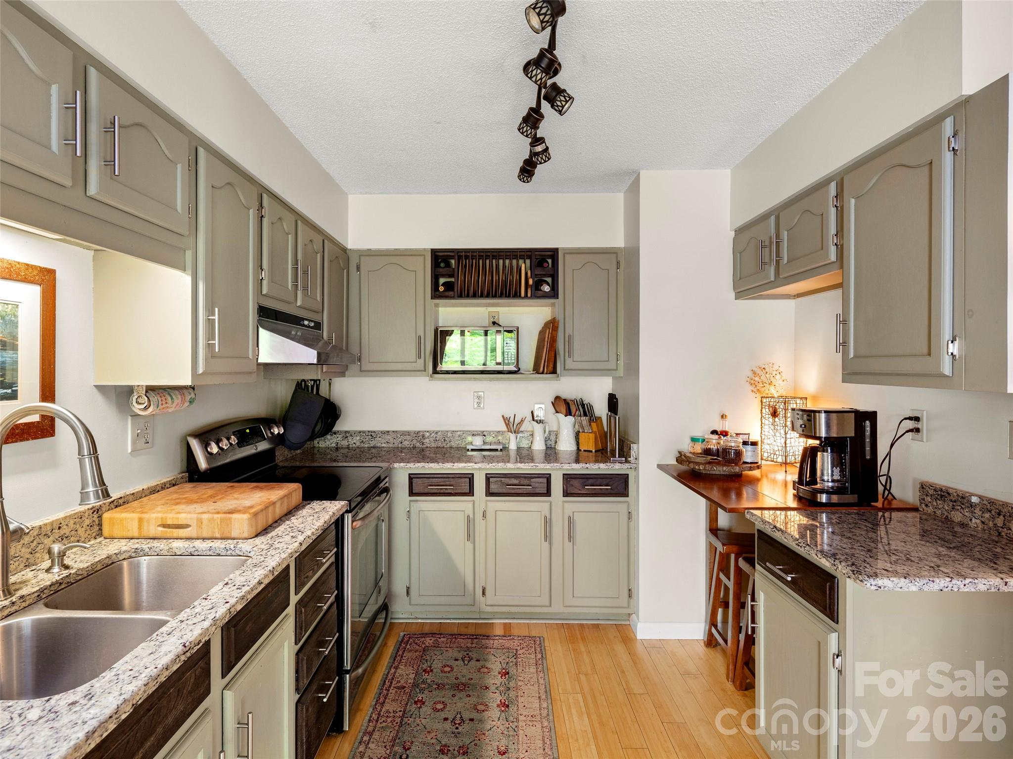 756 Pole Creasman Road Asheville, NC 28806 - Photo 15 of 29 a kitchen with a sink stove top oven and cabinets