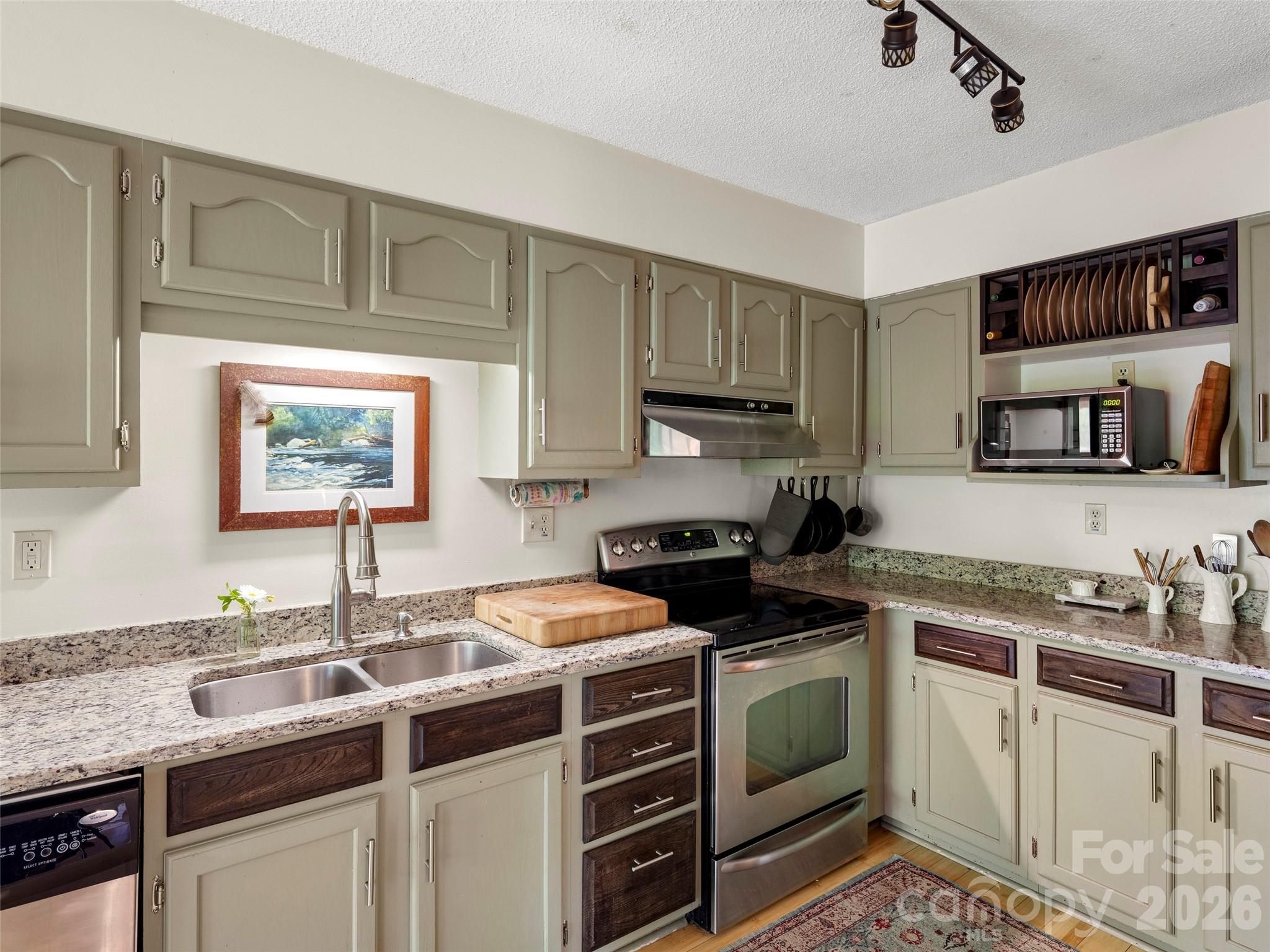 756 Pole Creasman Road Asheville, NC 28806 - Photo 16 of 29 a kitchen with cabinets appliances a sink and a counter top space