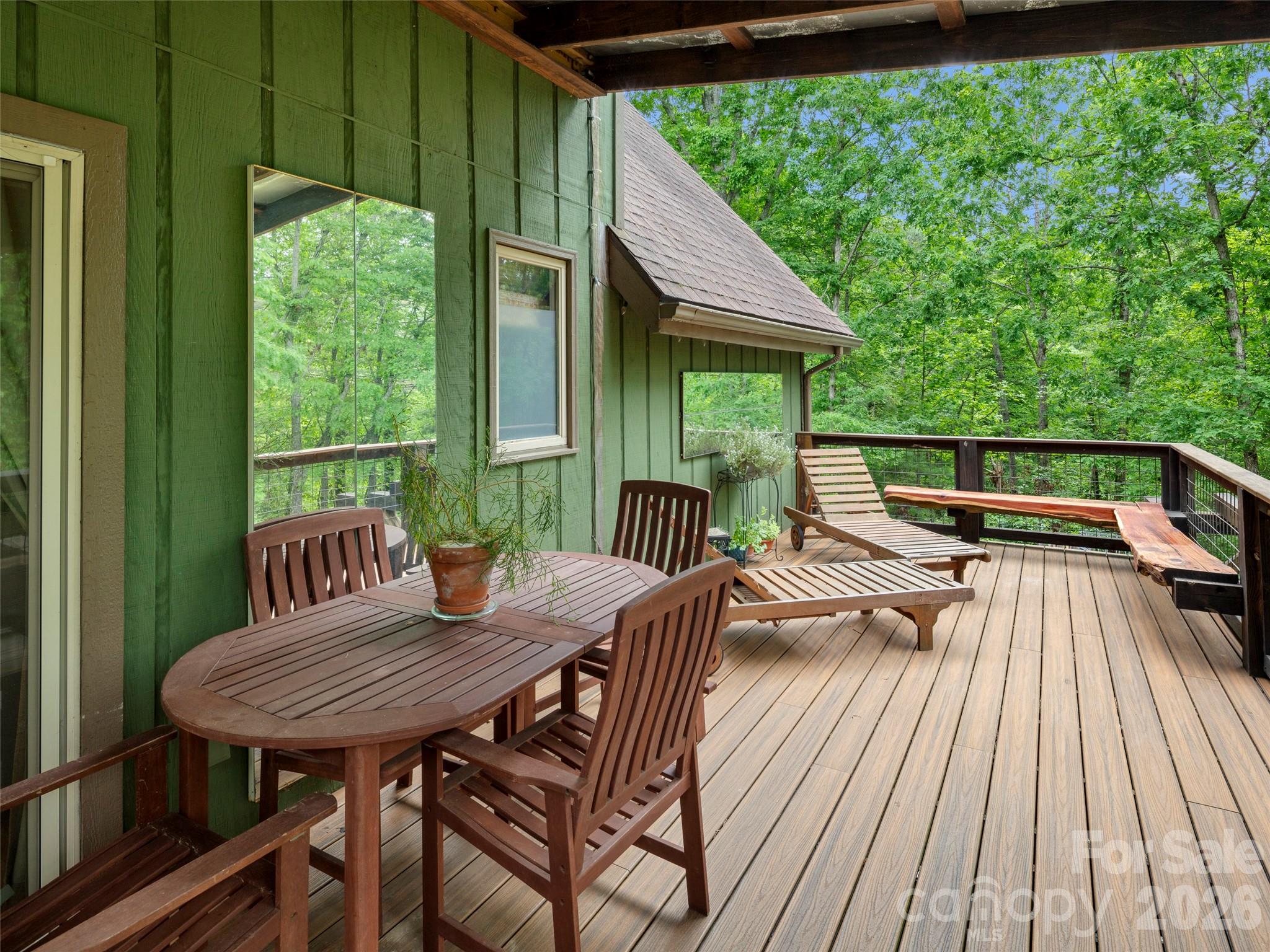 756 Pole Creasman Road Asheville, NC 28806 - Photo 22 of 29 a view of a chairs and table on the deck