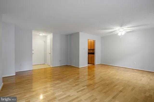 a view of an empty room with wooden floor