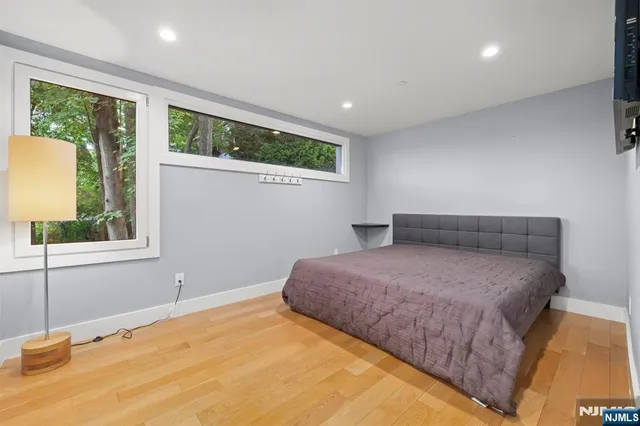 a view of a big room with windows and entryway of the house