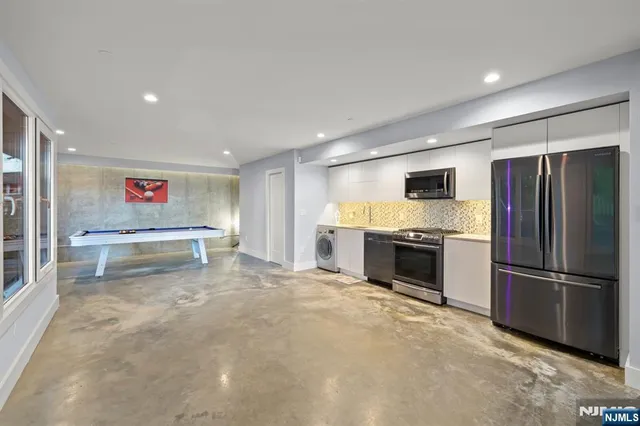 a kitchen with refrigerator and window
