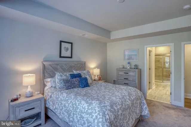 a bathroom with a granite countertop sink a mirror and shower