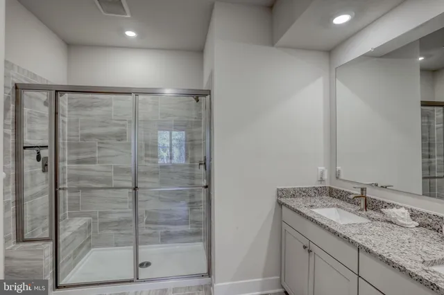 a view of walk in closet with clothes