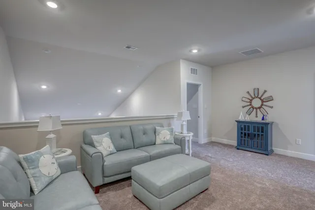a living room with furniture and a large mirror