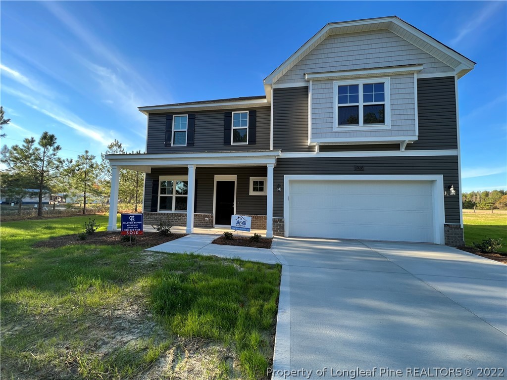 a front view of a house with swimming pool having outdoor seating
