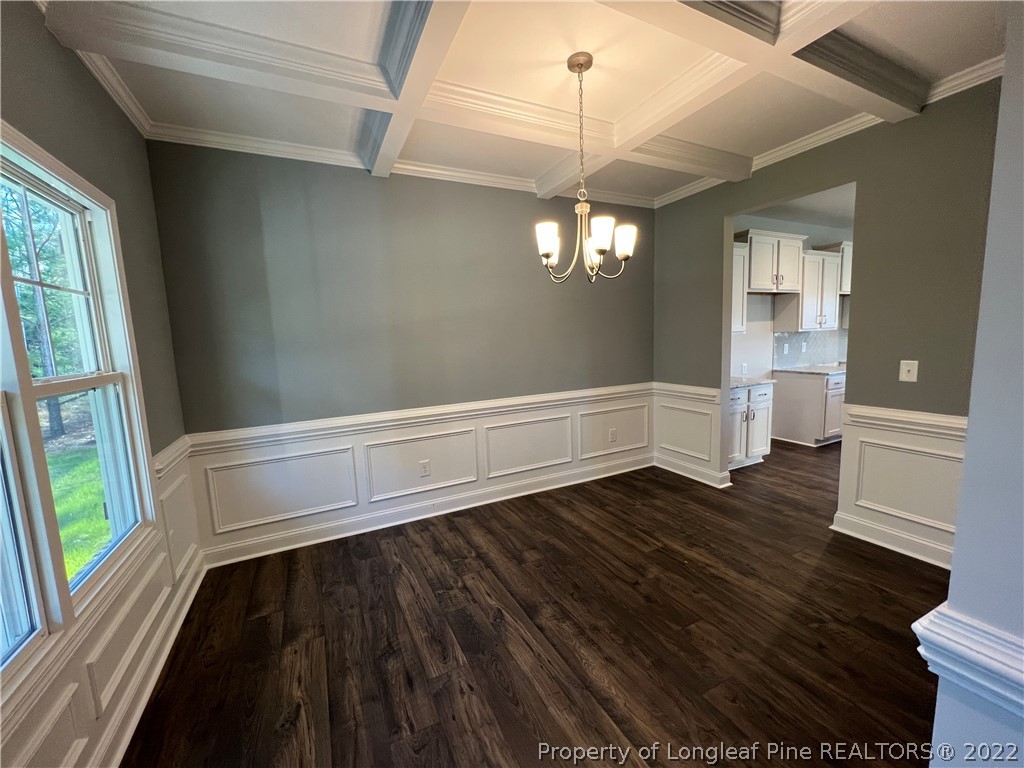 7850 Rufus Johnson Road Fayetteville, NC 28306 - Photo 2 of 11 a view of an empty room with wooden floor and a window