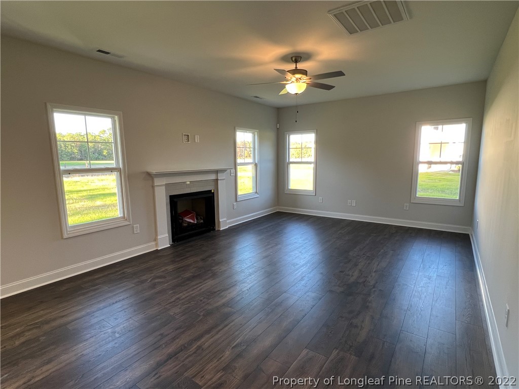 7850 Rufus Johnson Road Fayetteville, NC 28306 - Photo 3 of 11 a view of an empty room with wooden floor and a window