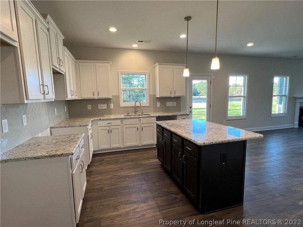 7850 Rufus Johnson Road Fayetteville, NC 28306 - Photo 5 of 11 a kitchen with a stove sink and cabinets