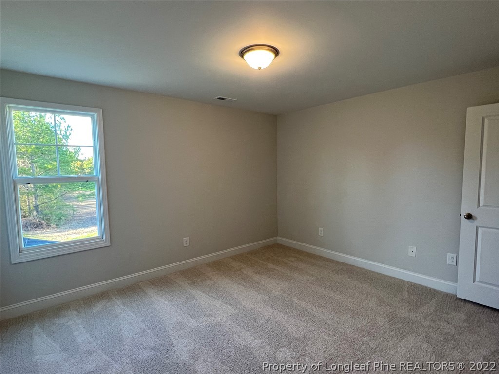 7850 Rufus Johnson Road Fayetteville, NC 28306 - Photo 8 of 11 a view of an empty room with a window