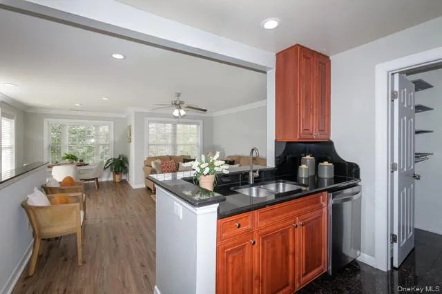 a kitchen with granite countertop a sink and cabinets