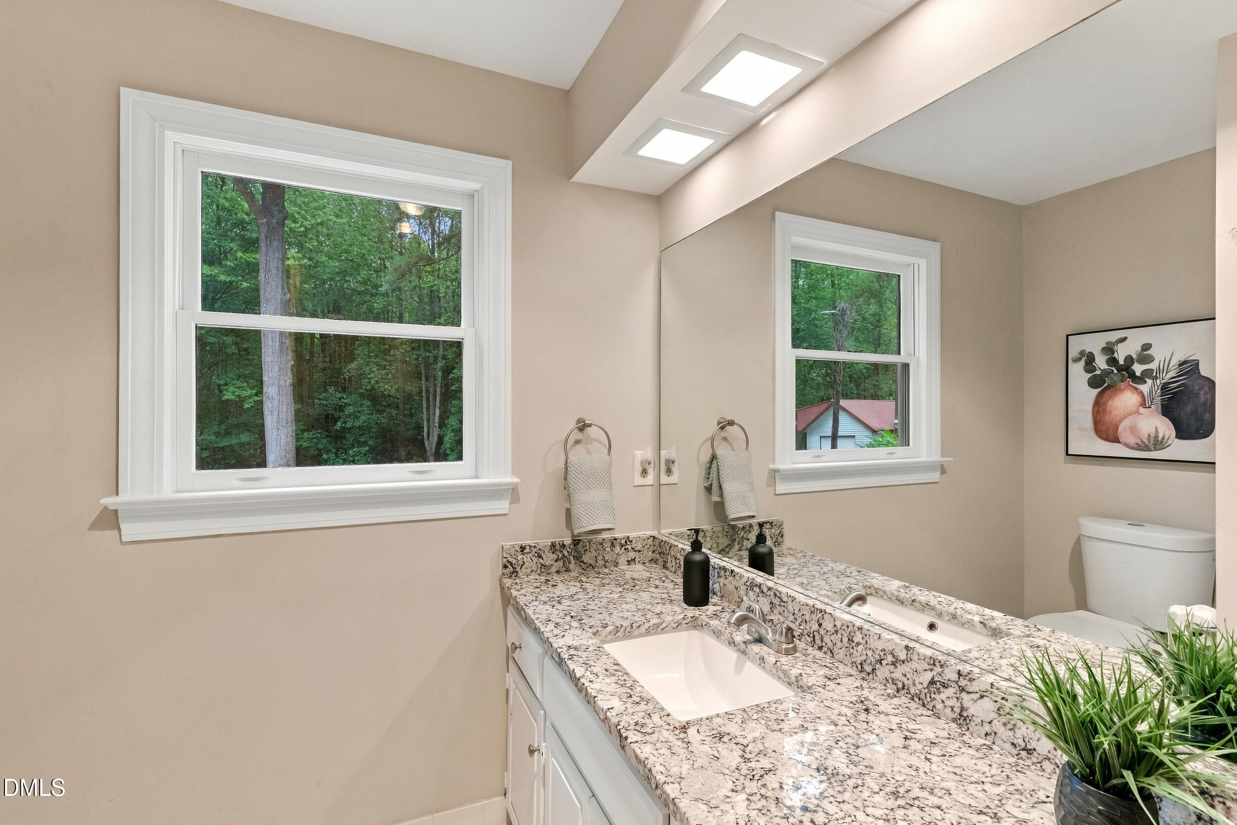 2329 Win Road Garner, NC 27529 - Photo 51 of 90 Vanity with an integrated rectangular sink, speckled countertop, and a large mirror