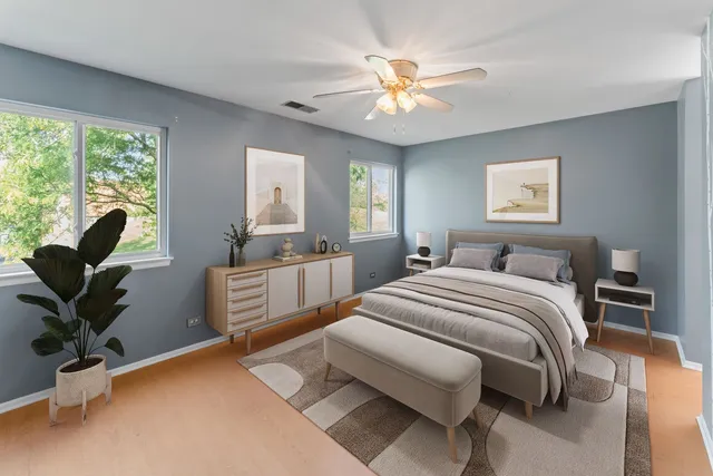 a bedroom with a large bed and a chandelier