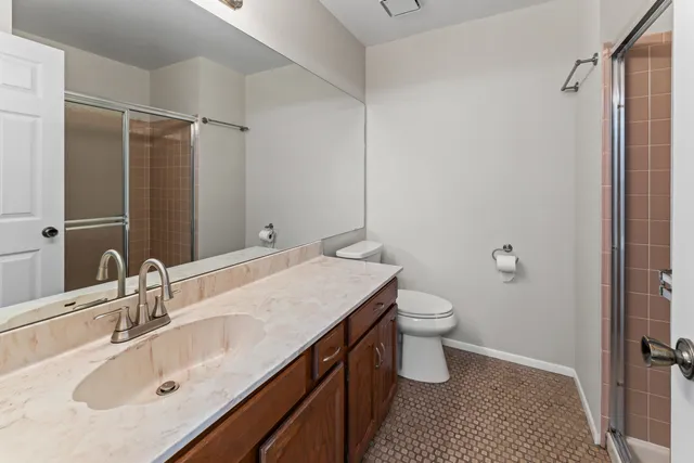 a bathroom with a sink toilet and shower