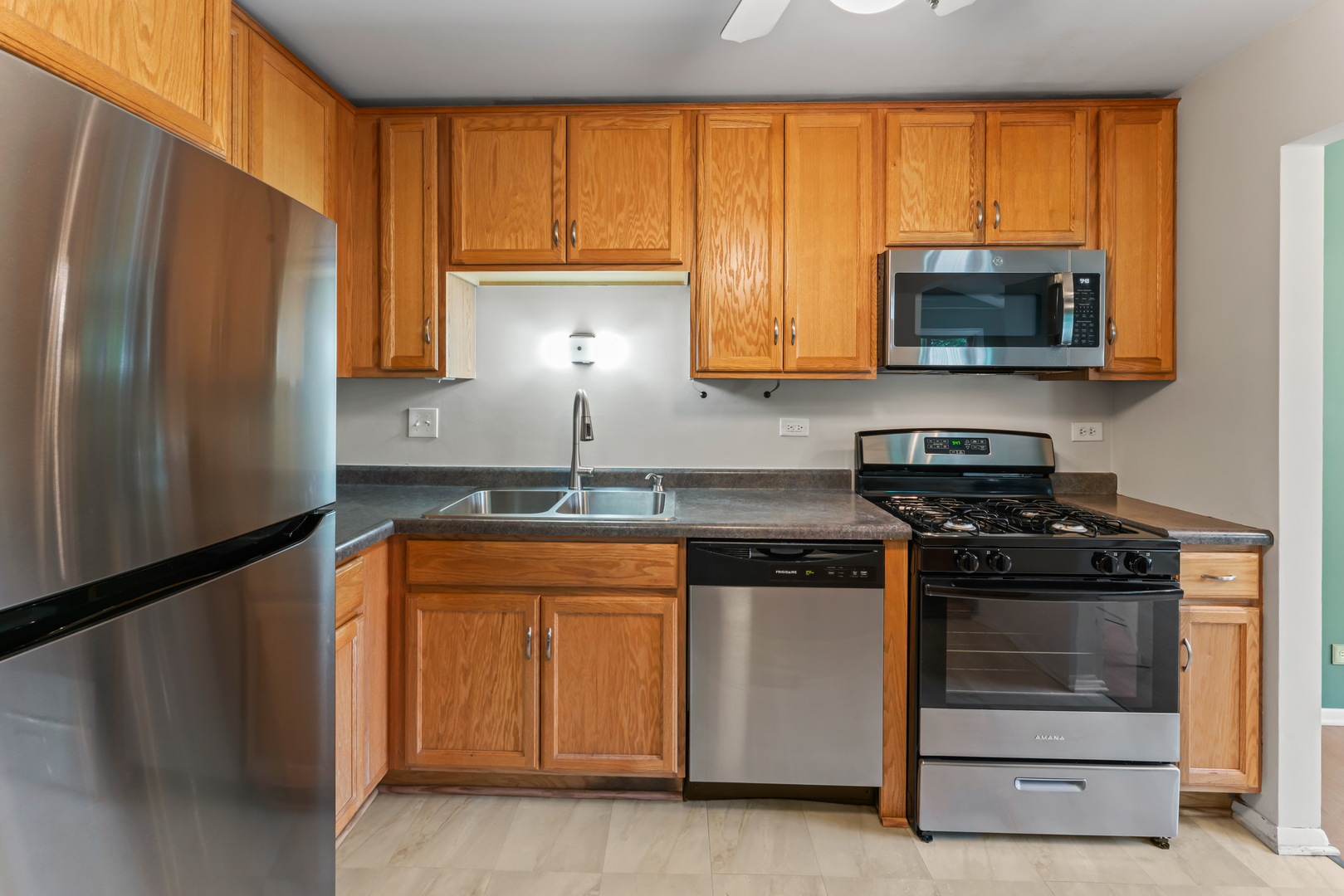 601 Hanover Court, Unit Z2 Schaumburg, IL 60194 - Photo 9 of 22 a kitchen with a sink a stove and a refrigerator