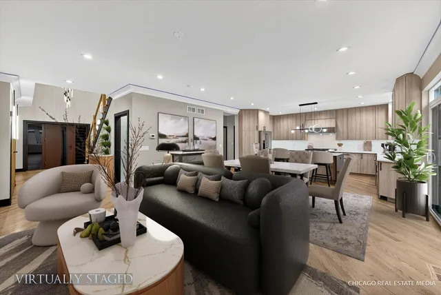 a kitchen with kitchen island wooden floors appliances and cabinets