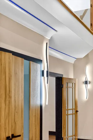 a view of hallway with stairs and wooden floor