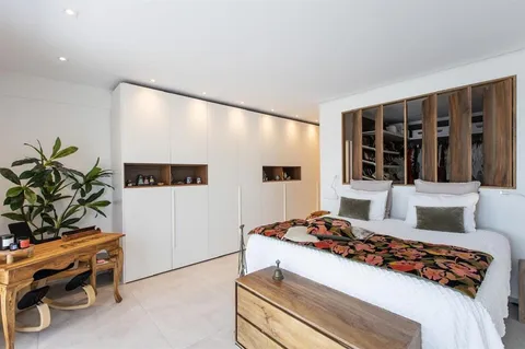 a bedroom with furniture and a potted plant