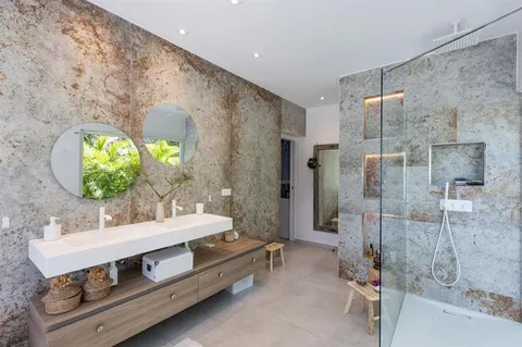 a bathroom with a double vanity sink mirror and shower