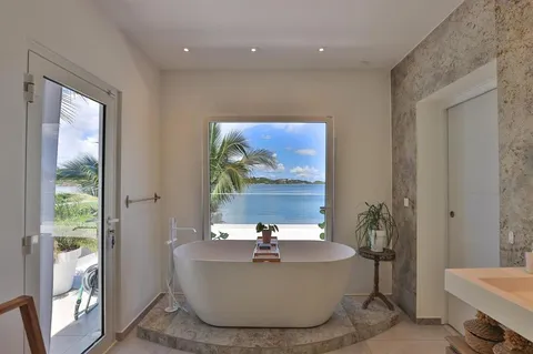 a living room with a large window and a table