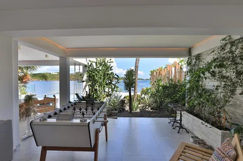 a view of a patio with couches table and chairs and potted plants
