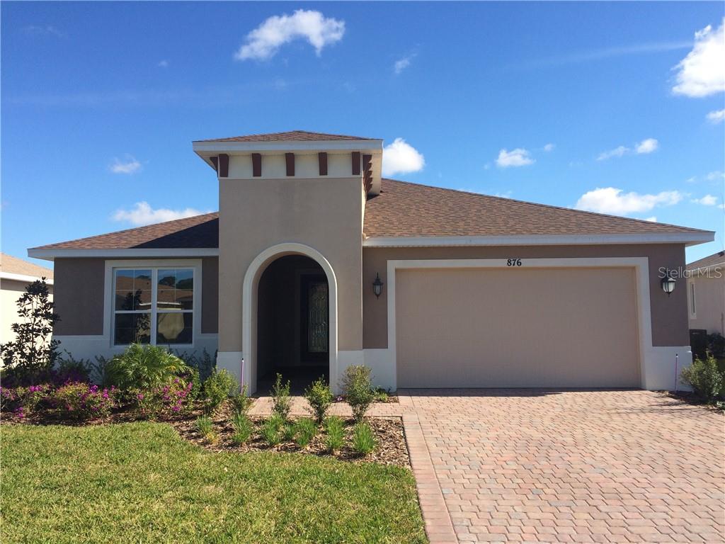 876 Pacific Ridge Road Poinciana, FL 34759 - Photo 1 of 1 a front view of a house with a yard